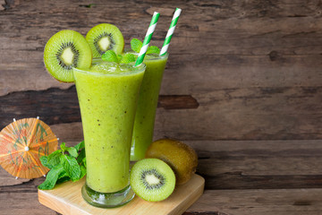 Kiwi yogurt fruit juice smoothie green colorful fruit juice milkshake blend beverage healthy high protein the taste yummy In glass,drink episode morning on wood background.