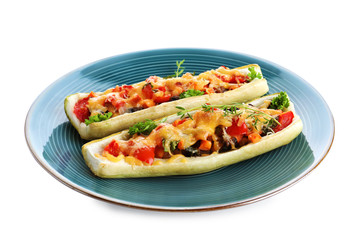 Plate of delicious stuffed zucchini on white background