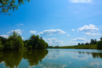 Fototapeta na wymiar Lake with reflecting clouds. Summer time. Russia