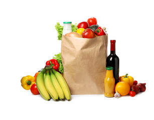 Paper bag with groceries on white background