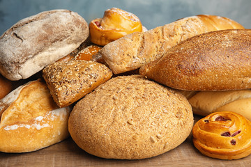 Fresh breads and pastries on wooden table