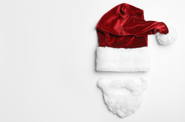 Santa Claus hat with beard on white background, top view