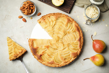 Cut delicious sweet pear tart on grey table, flat lay