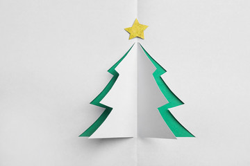 Christmas tree cut out of white paper, top view