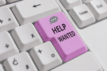 Handwriting text writing Help Wanted. Conceptual photo An ad in the paper an employer places to find a new employee White pc keyboard with empty note paper above white background key copy space