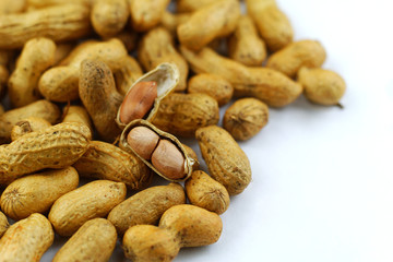 Roasted peanuts in shell on white paper