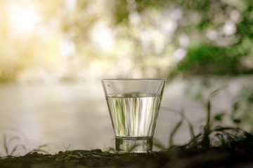 A glass of clean water, on the nature. Concept of a healthy life