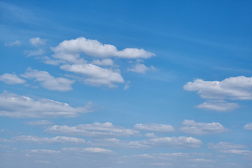 Naklejka premium The sky on a Sunny summer day. Background clouds on blue sky. White Cumulus clouds in clear weather.