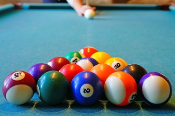 Playing billiard pool game with colorful balls