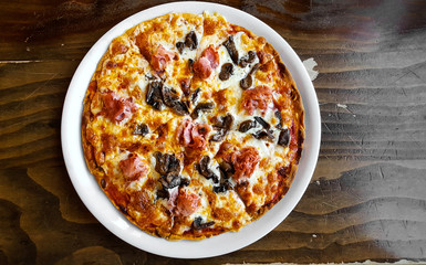 Italian fast food. Pizza with ham and mushrooms, top view. Menu photo.