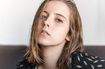 Blonde girl photographed inside a house.