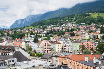 Fototapeta na wymiar Traditional light colored houses along the river Inn in the city of Innsbruck, Austria