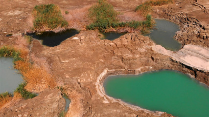 Sinkholes With water in dead sea aerial view 