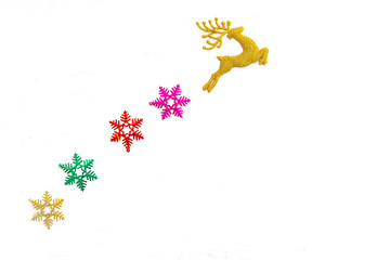 Beautiful golden reindeer toy and 4 snow flakes isolated on white background, Christmas tree decoration.