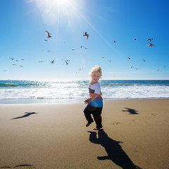 Happy and free boy on the beach with seagulls © Maygutyak