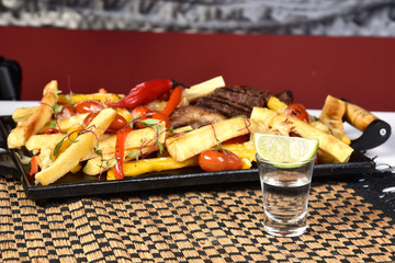 Club Beef steak with pepper sauce and Grilled vegetables on cutting board on dark wooden background