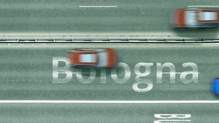 Aerial top down view of the road with cars revealing Bologna caption. Car travel in Italy conceptual clip