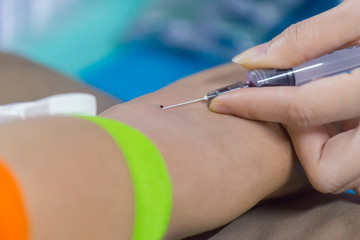 Nurse collecting a blood from patient in hospital