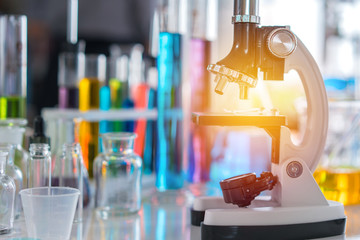 scientist with equipment and science experiments, laboratory glassware containing chemical liquid for research or analyzing a sample into test tube in laboratory