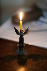 Church candle in angel candle holder