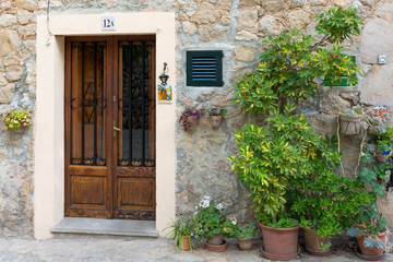 Fototapeta na wymiar Valldemossa. Entrance door to the house decorated with flower pots