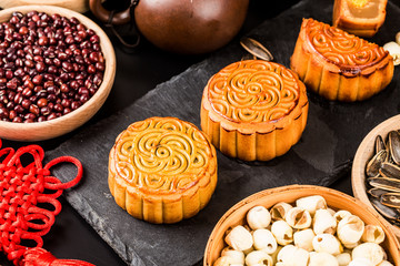 Traditional mooncakes on table setting with teacup.