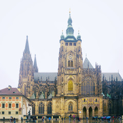 Fototapeta na wymiar St Vitus Cathedral - Gothic Catholic Cathedral in Prague Castle. Panoramic view on a rainy spring day.