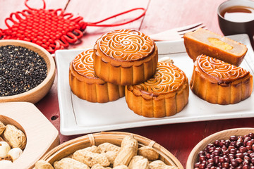 Traditional mooncakes on table setting with teacup.
