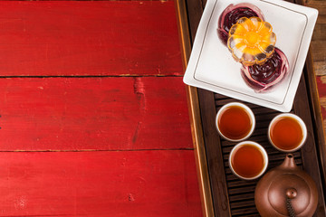 Traditional mooncakes on table setting with teacup.