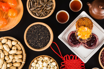 Traditional mooncakes on table setting with teacup.