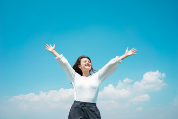 Portrait Asian woman traveller happy smiling show hand for relaxing with cloud sky. Green energy concept.