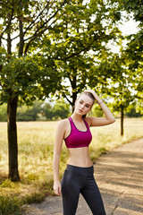 Fototapeta premium Blonde girl doing exercises in the park