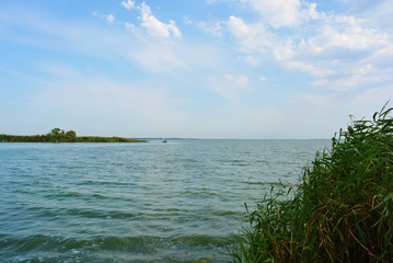 Beautiful view of the Samara River with picturesque steep banks and coast, trees, greenery and rich sky. Bright and unforgettable nature in the housing estate, Shevchenko, Dnipro, Ukraine.