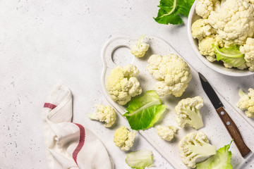 Chopped cauliflower on cutting board. Top view, copy space.