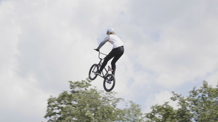 MOSCOW - JUNE 23: Jumping on trampoline with bike, extreme sports at slow motion on June 23, 2019 in Moscow, Russi