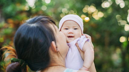 Family portrait of Asian people : 4 months newborn baby feeling happy loving and smiles while playing with her mother. Concept for love and parents.