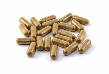 herb capsule with herbal leaf isolated on white background