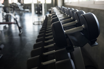 Black steel dumbbell in fitness gym