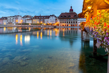 Lucerne. The famous Chapel, Kapellbrucke bridge at dawn in night lighting.