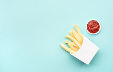 Top view of french fried with tomato sauce ( ketchup ) on blue pastel table background