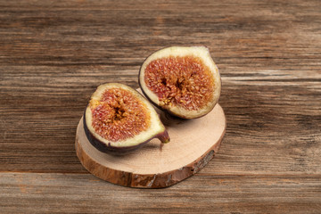 ripe fig fruit cut in half on a wooden table