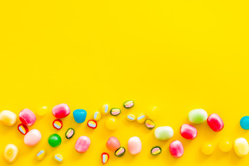 Assorted sweets and marmalade on yellow background top view space for text
