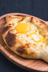 khachapuri or hachapuri with egg and cheese. Ajarian traditional flatbread.
