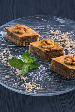 Pieces of Turkish or arabic traditional declious oriental dessert pahlava, baklava, tree pieces on a plate