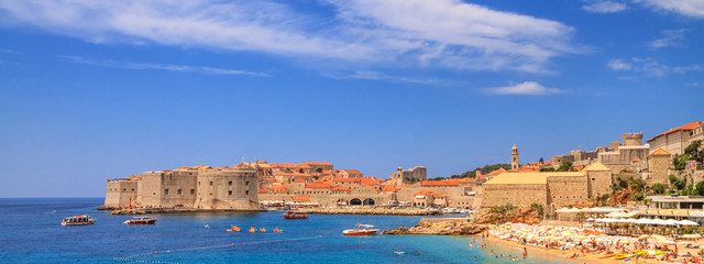 Coastal summer landscape, banner - view of the city beach and the Old Town of Dubrovnik on the Adriatic coast of Croatia