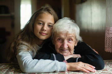 Child of eleven with his grandmother posing for portrait.