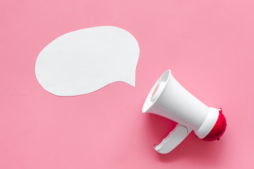 bubble for text and megaphone on pink background top view space for text