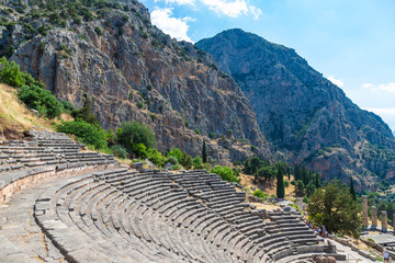 DELPHI / GREECE - JUNE 29, 2019: Ancient theater remains in the archaeological site of Delphi in Greece