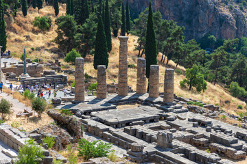 Fototapeta na wymiar DELPHI / GREECE - JUNE 29, 2019: Apollo Temple in Delphi archaeological site at the Mount Parnassus. Delphi is famous by the oracle at the sanctuary dedicated to Apollo.