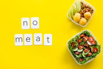 Healthy dinner in lunch box and no meat text on yellow background top view